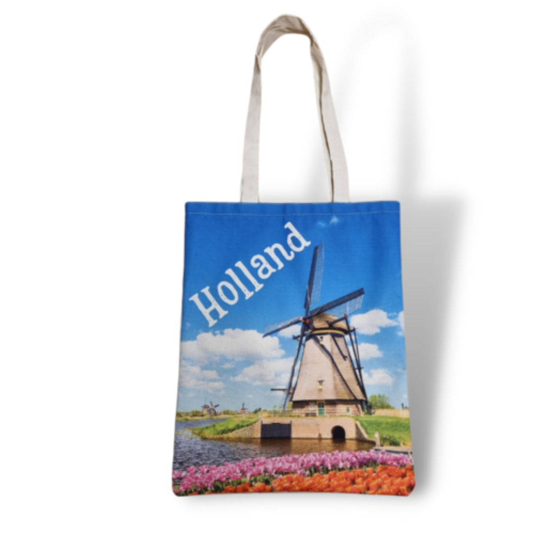 Katoenen canvas draagtas bedrukt met een Hollandse windmolen tegen een blauwe lucht, ideaal voor dagelijks gebruik of als geschenk.
